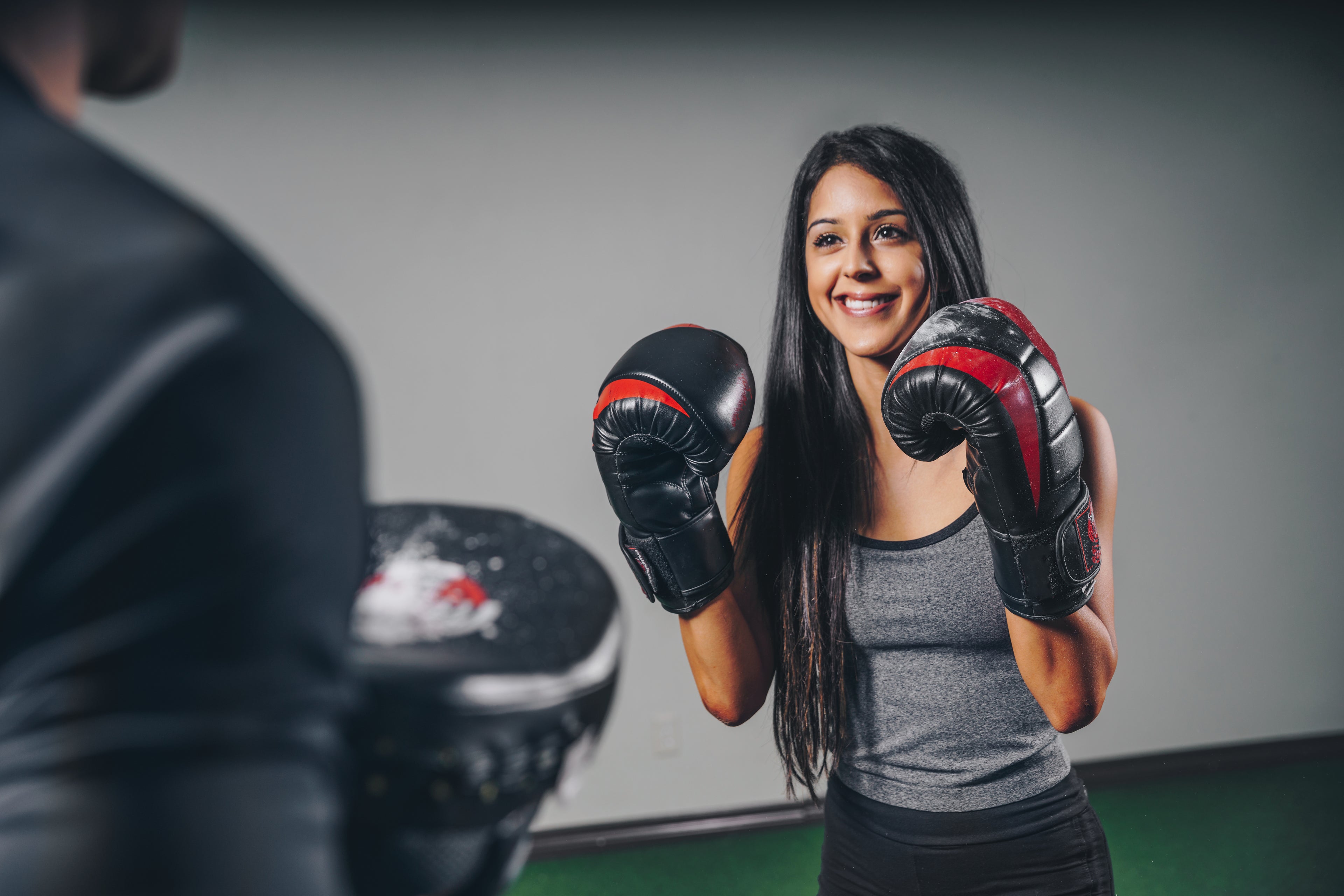 A Woman trained by a Female Fitness Trainer doing Weightlifting in PFC Club 